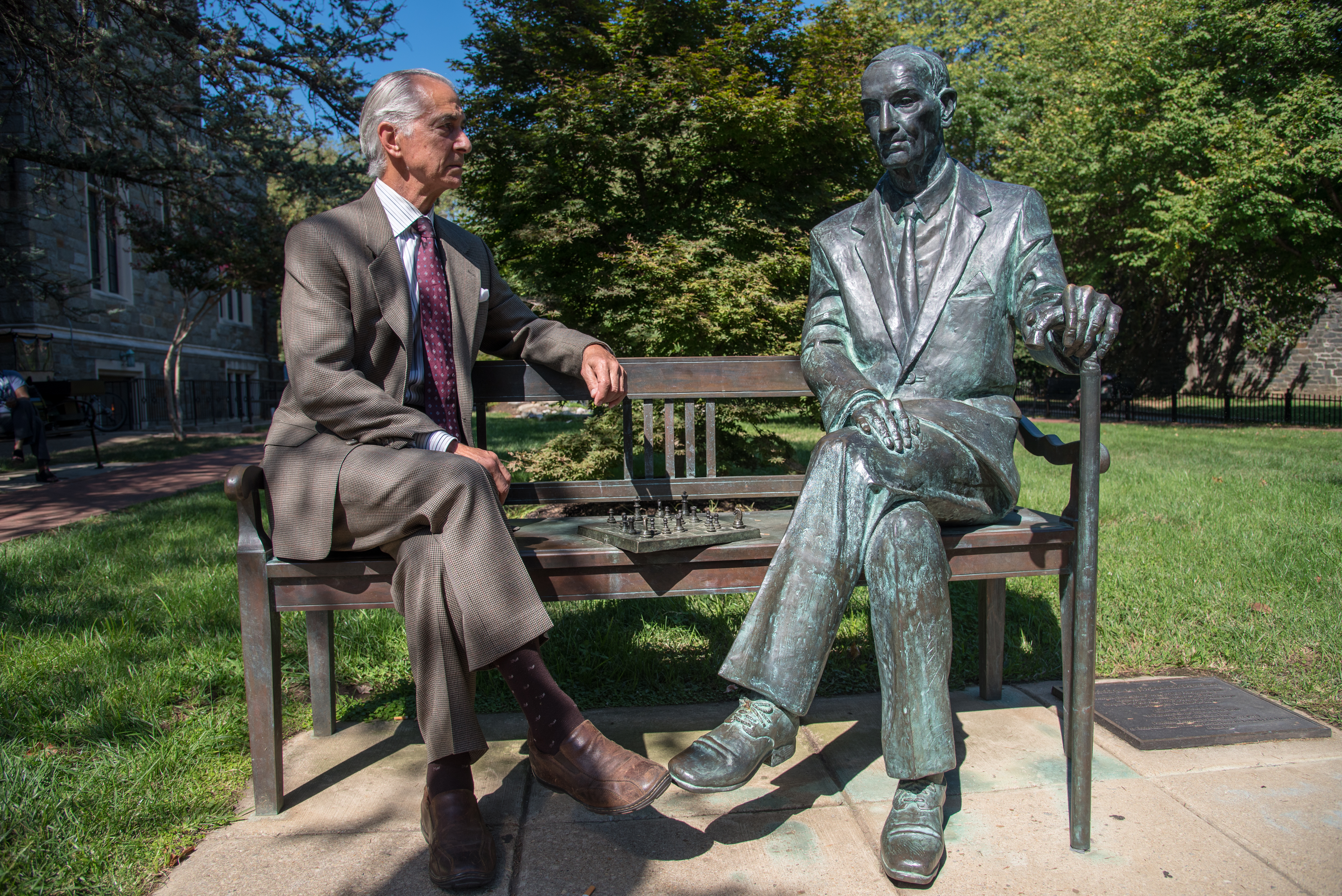 David Strathairn sitting with statue