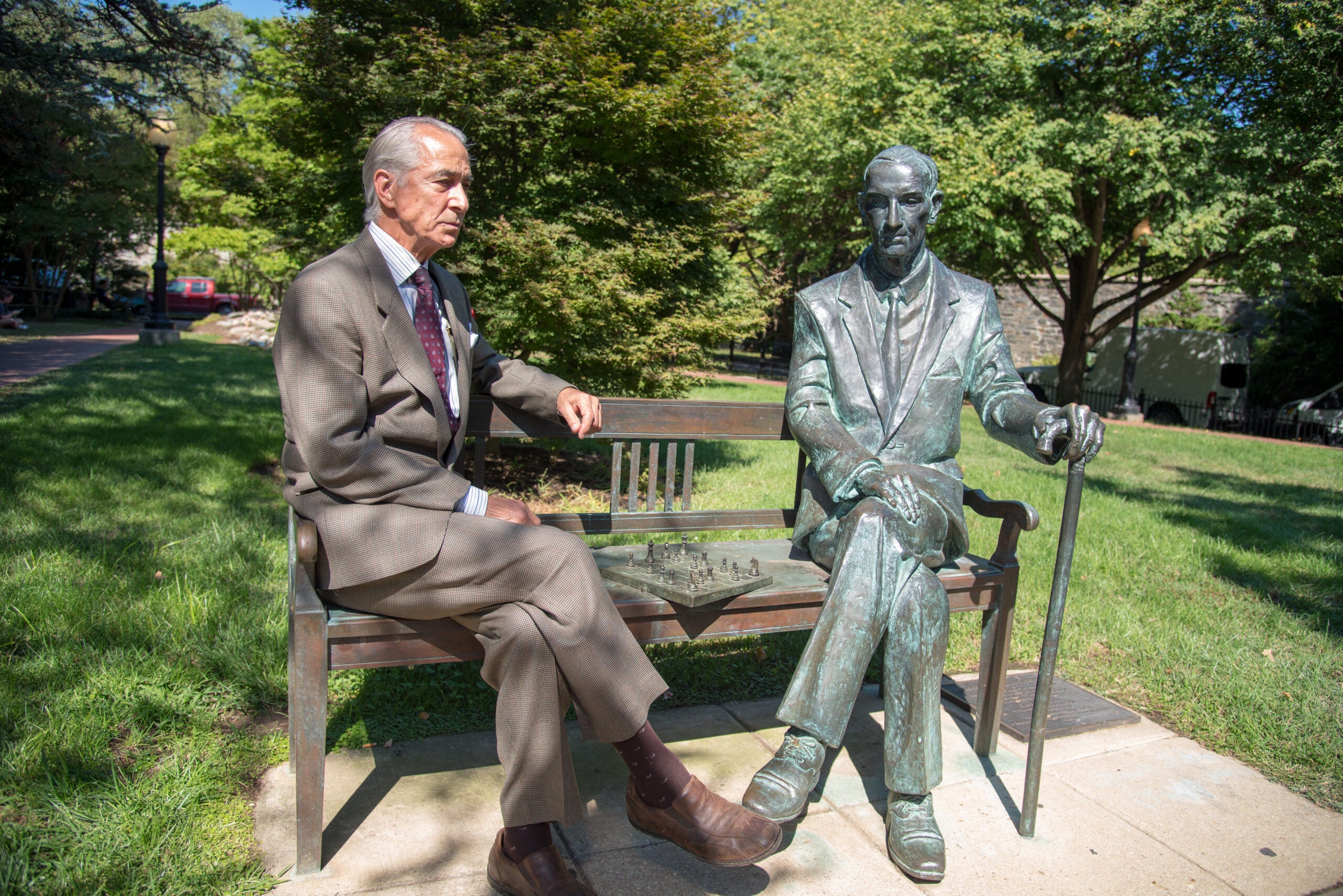 David Strathairn sitting with statue