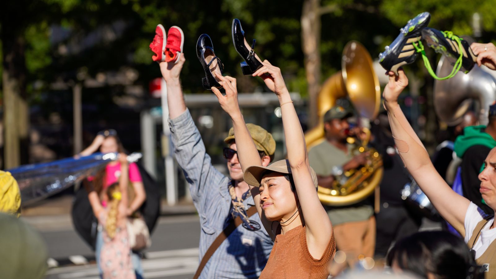 Performers help up shoes to symbolize the millions of refugees and children on the move in the world.